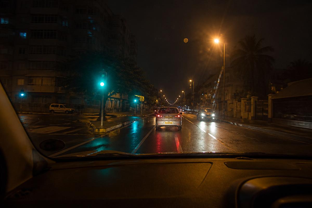 View through a car windscreen of a wet Cape Town street at night